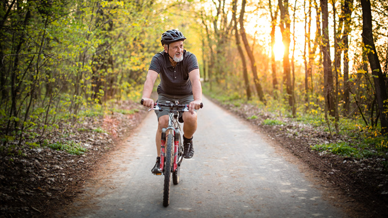 Man riding a bike on trail