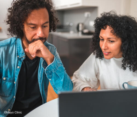 Two people looking at laptop