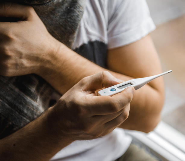 Person reading a thermometer