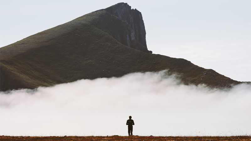 Person walking toward mountain