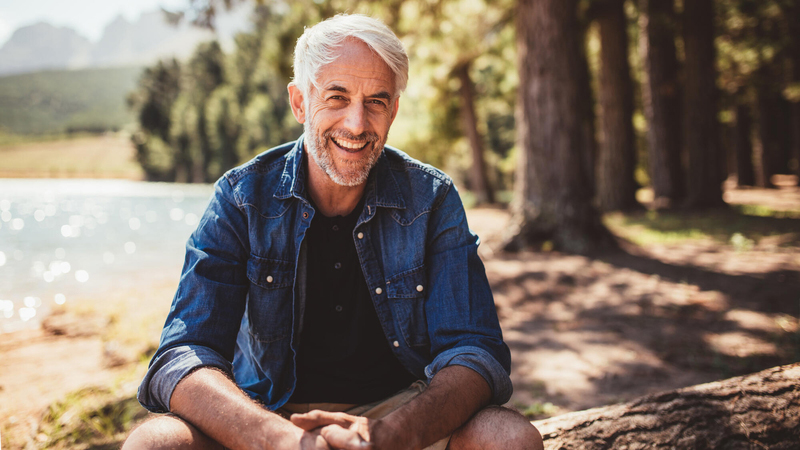 Man in woods smiling