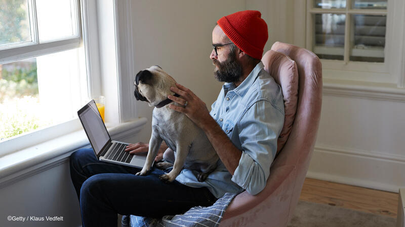 Man and dog sitting near a window