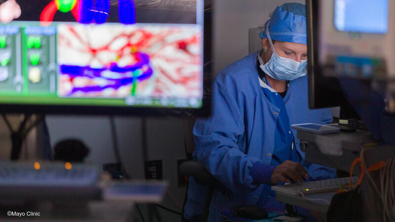 Surgical staff using computer in operating room.