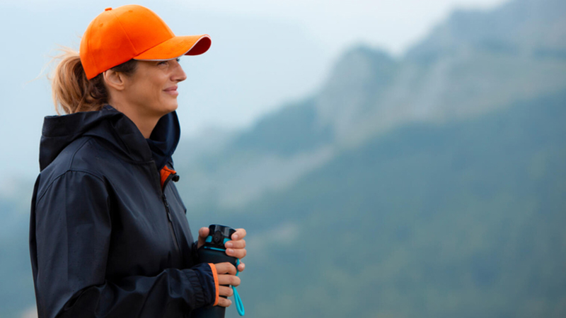 Hiker in mountains smiling with camera