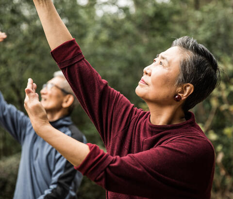 Man and woman doing gentle exercising outside