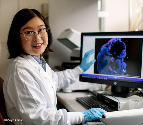 Researcher showing computer screen