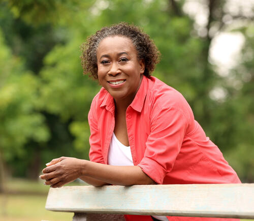 Woman leaning on railing outside