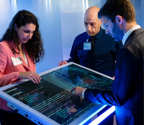 Medical team working on a large computer screen