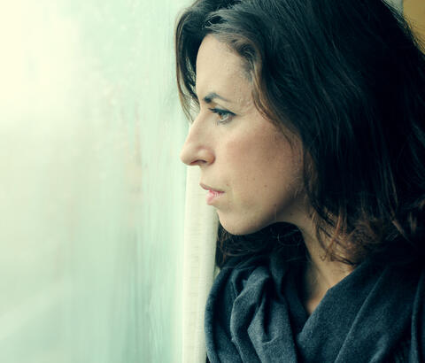 Woman looking out window