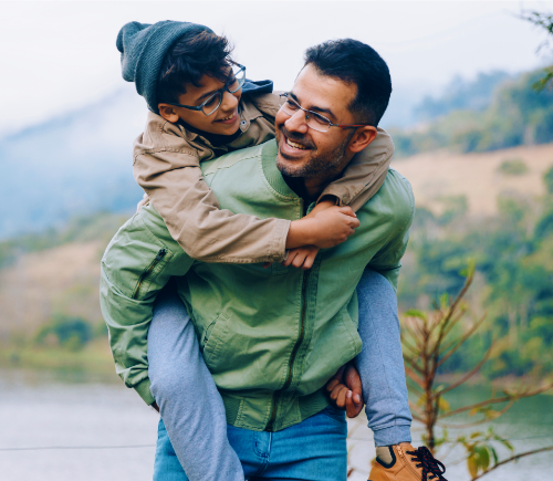 Kid getting a piggyback ride from parent