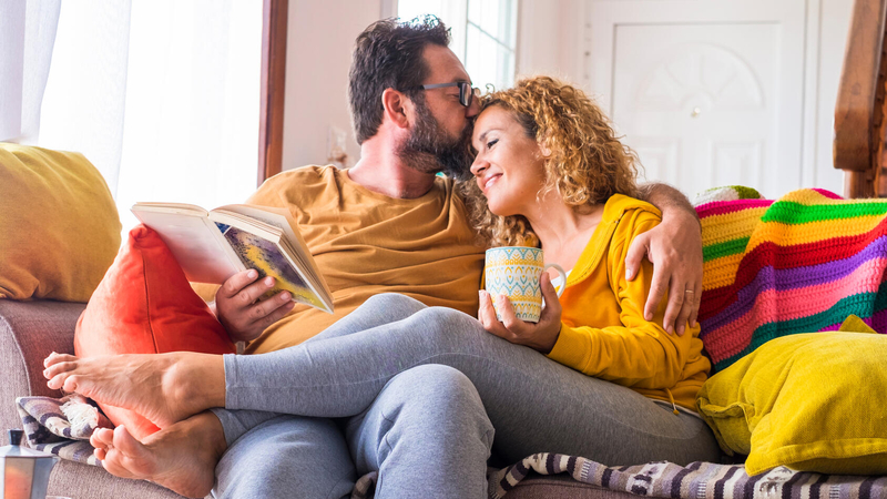 A couple relaxing on a sofa