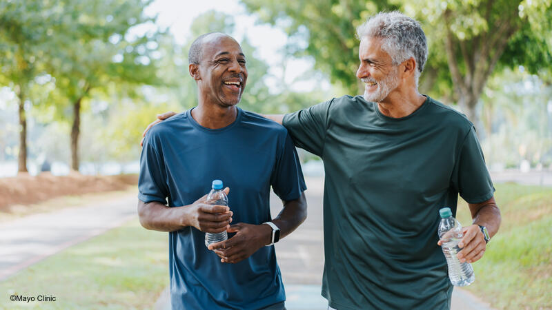 Two men walking and laughing with each other