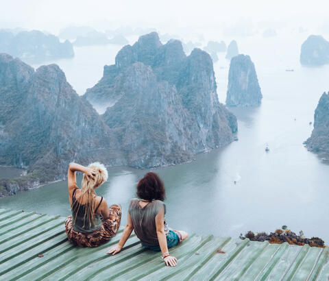 Friends looking out at scenic rocky isles