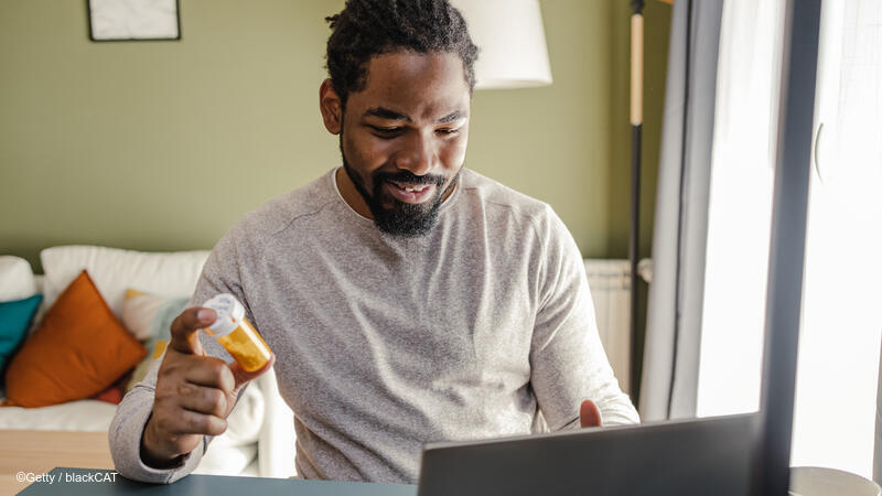 Man holding prescription bottle