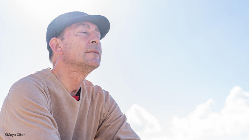 Man sitting in the sun with his eyes closed