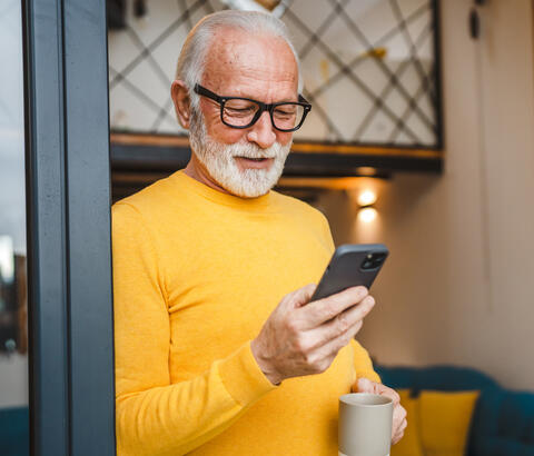 Older man holding smartphone