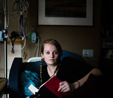 Patient sitting in chair reading