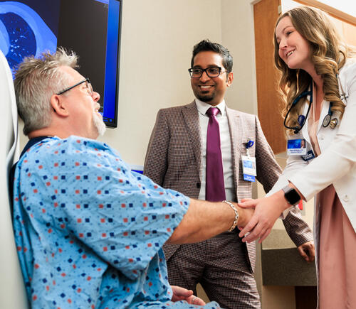 A patient speaking to two physicians