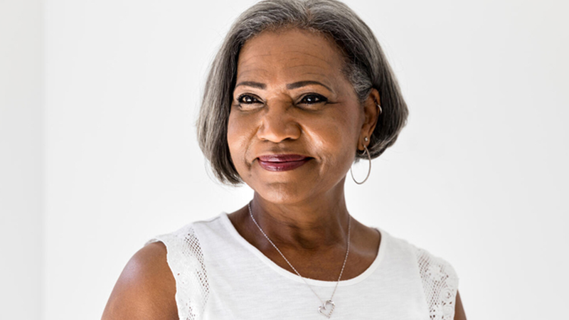 Older woman in white smiling