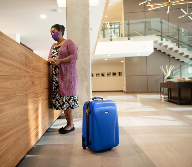 Woman at check in counter with suitcase