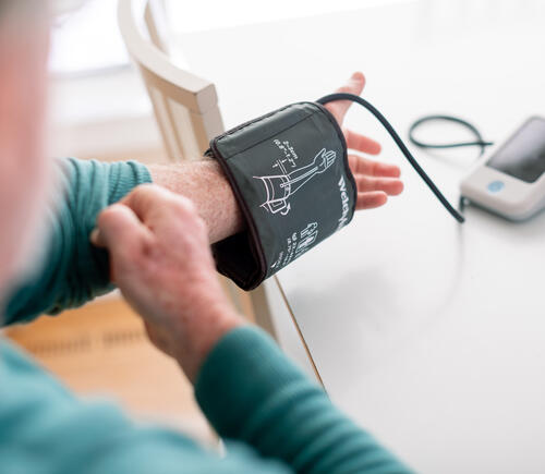 Man using blood pressure cuff