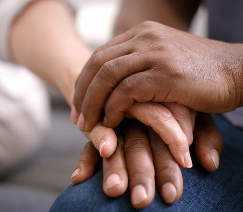 Two adults holding hands