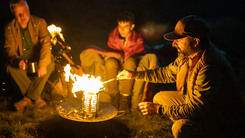 Family sitting around a campfire