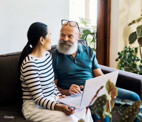 Couple using laptop together