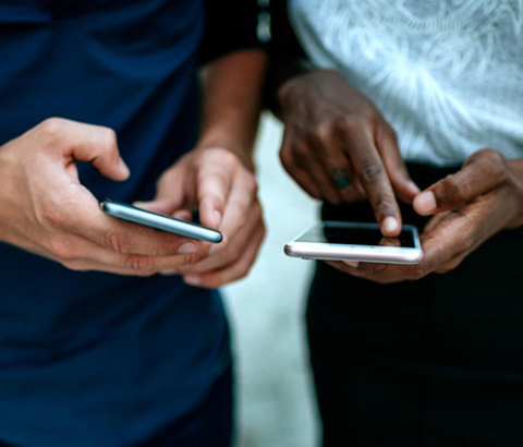 Two people using their phones