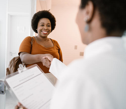 Woman shaking a doctor's hand