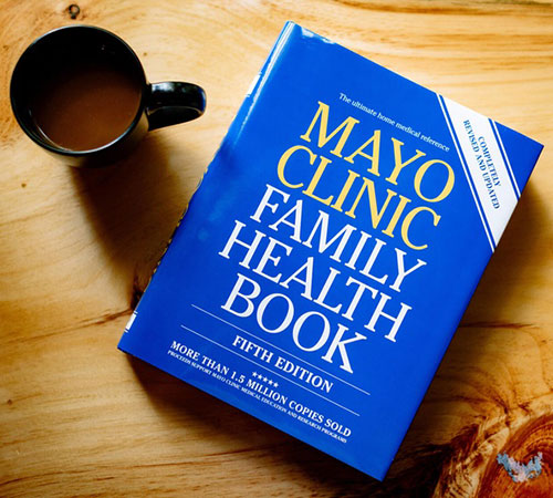 Mayo Clinic Family Health Book on a table with cup of coffee