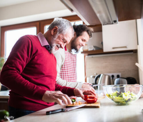 Elderly father and son preparing food