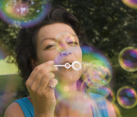 Woman blowing bubbles