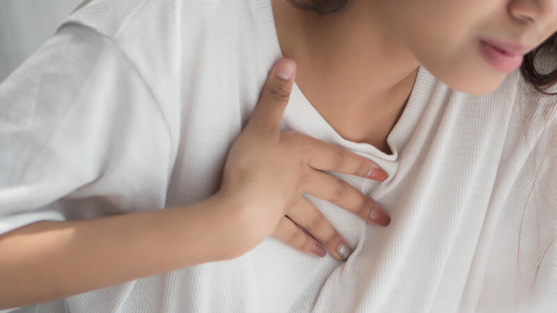 Woman holding her chest