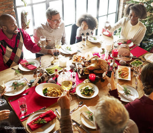 Family around table during Christmas dinner.