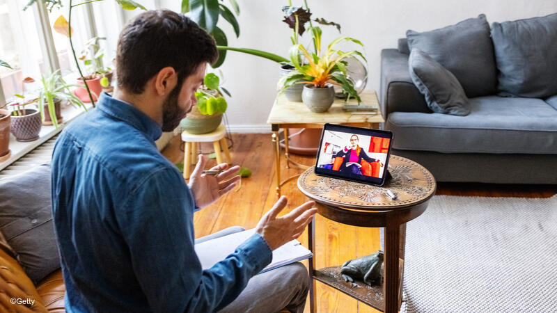 Man taking a video call on his tablet.