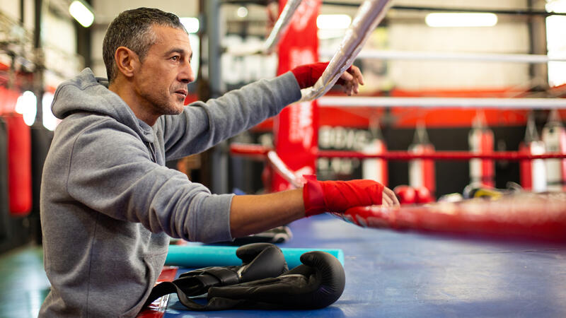 Man leaning on a boxing ring