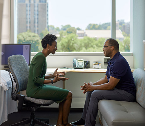 Doctor talking with patient in office