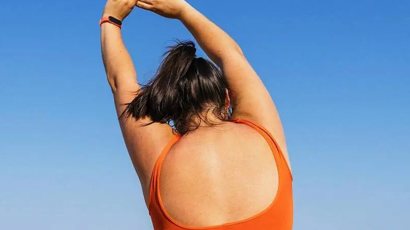 Woman stretching with arms overhead