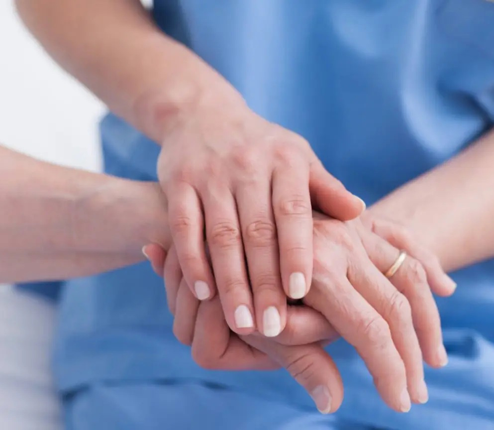 Provider holding patient hand