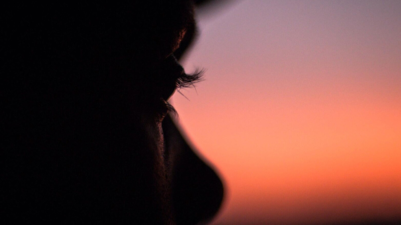 Closeup of the face of a person looking at sunset