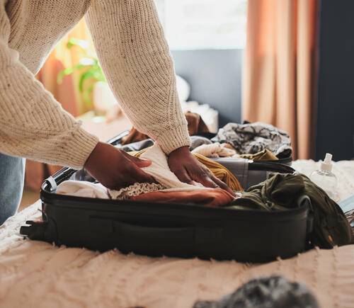 Person packing their suitcase