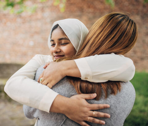 Two friends hugging