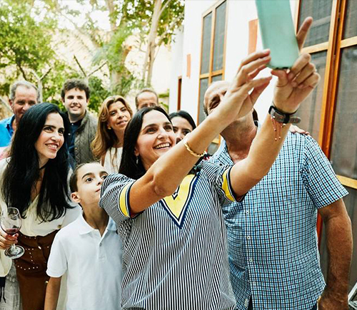 Woman taking a selfie with her family