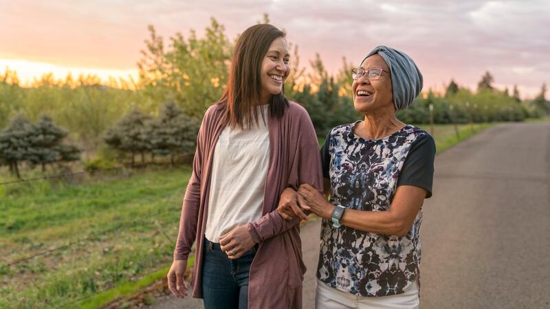 Woman and her mother walking outside