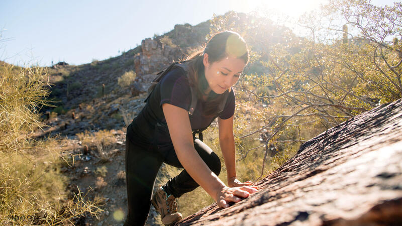 Woman hiking steep mountain