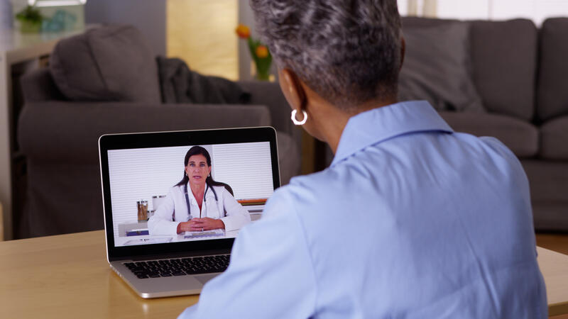 Woman watching video on laptop