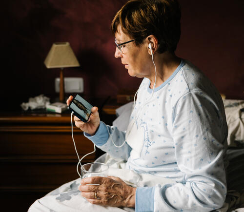 Woman using her phone for a telehealth consult