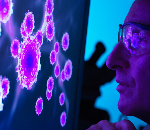 Researcher looking at cancer cells