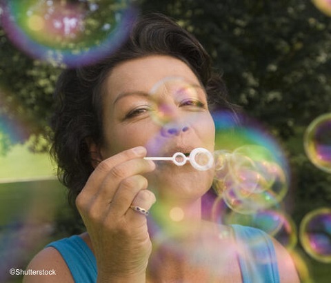 Woman blowing bubbles